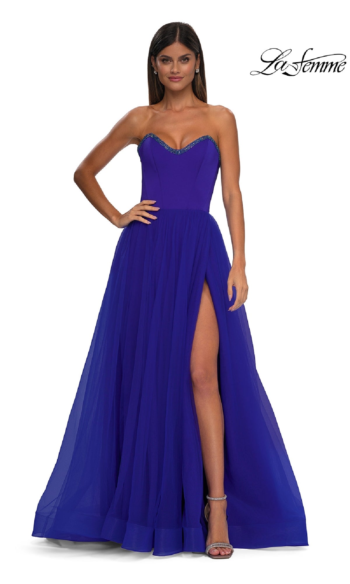 A woman stands against a plain white background wearing the La Femme 32731, a strapless royal blue long prom ball gown with a sweetheart neckline, floor-length silhouette, and high slit.